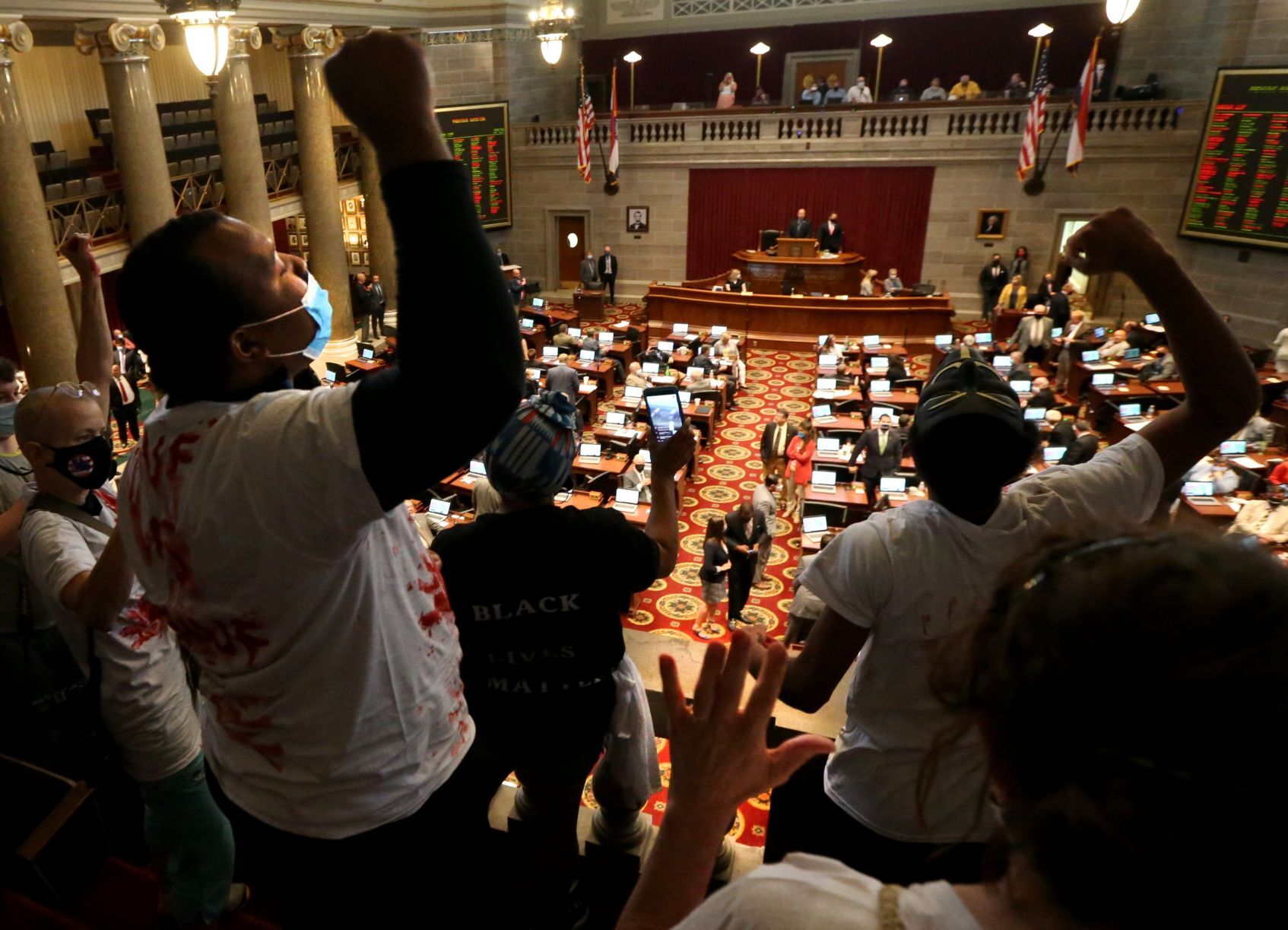ExpectUsSTL protesters drop poster during House debate